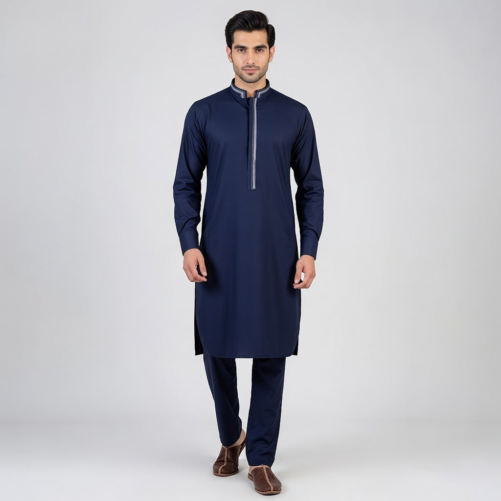 Man wearing a navy blue kurta with a white background