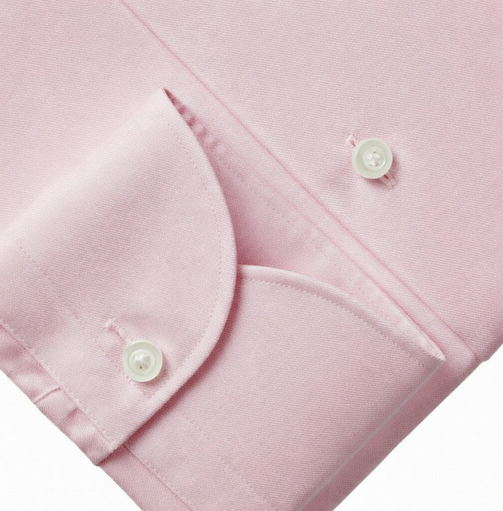 Close-up of a pink garment with buttons on a white background