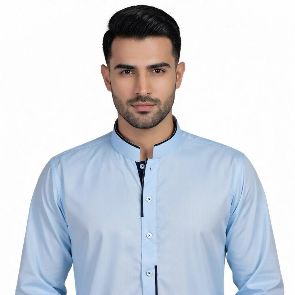 Man wearing a light blue shirt with a plain background
