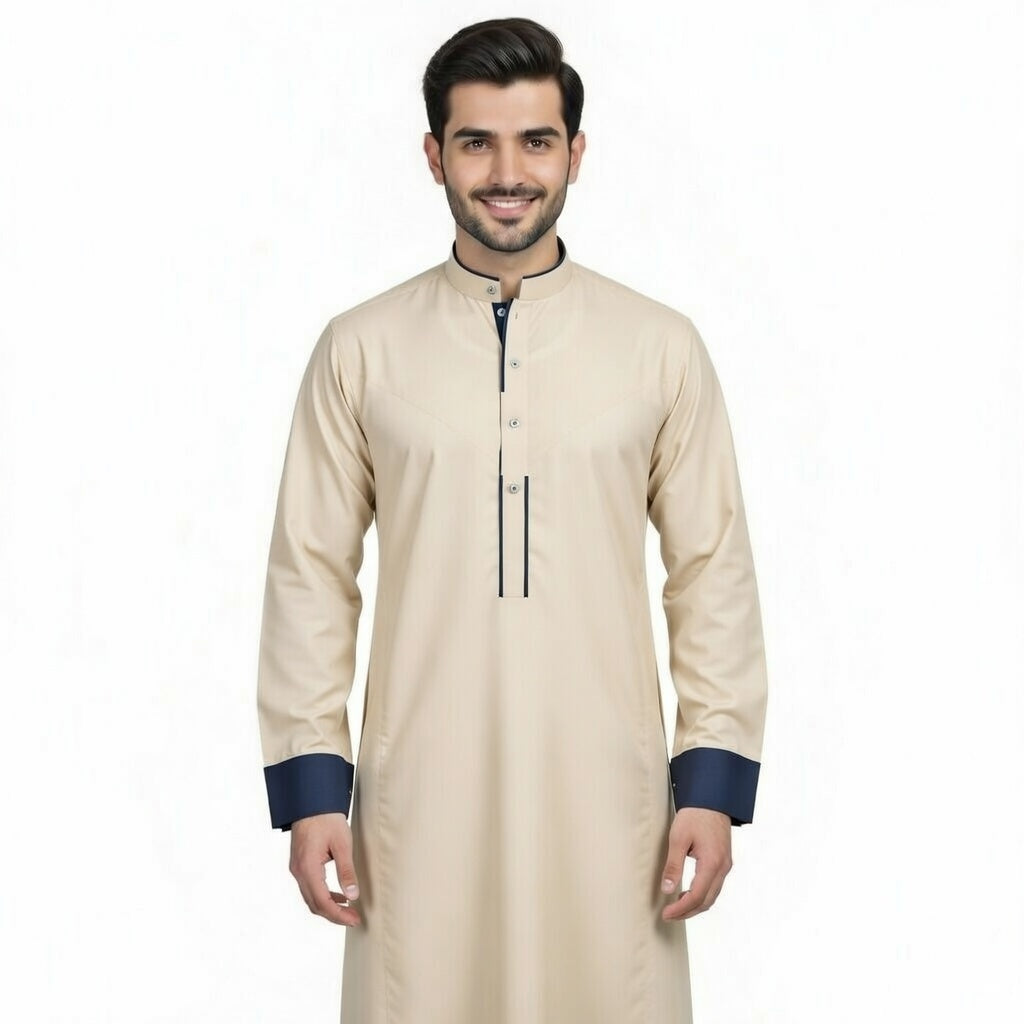 Man wearing a beige kurta with navy cuffs and trim on a white background