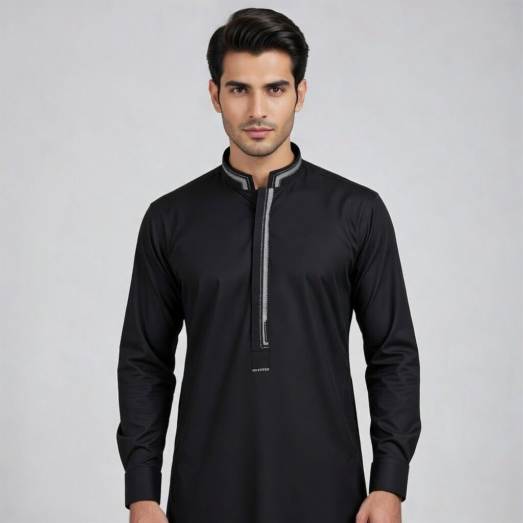 Man wearing a black long-sleeve shirt with a zipper on a gray background