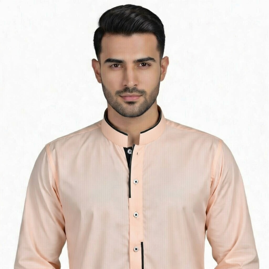Man wearing a peach-colored shirt with black trim on a white background