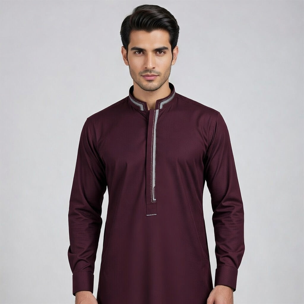 Man wearing a maroon long-sleeve shirt with a gray zipper on a light gray background