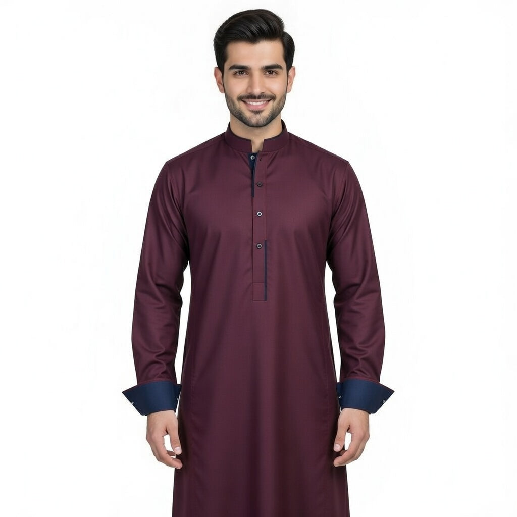 Man wearing a maroon long-sleeve shirt with blue cuffs on a white background