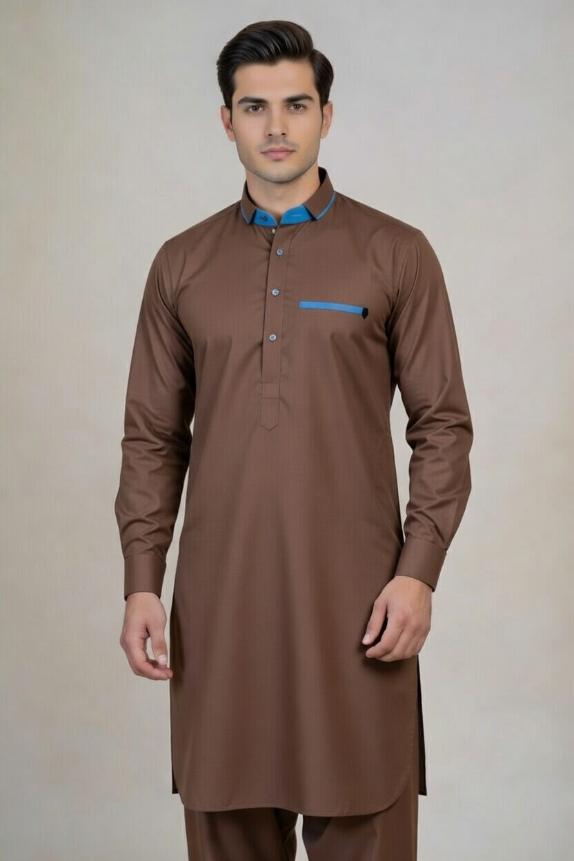 Man wearing a brown kurta with a blue shirt underneath on a beige background
