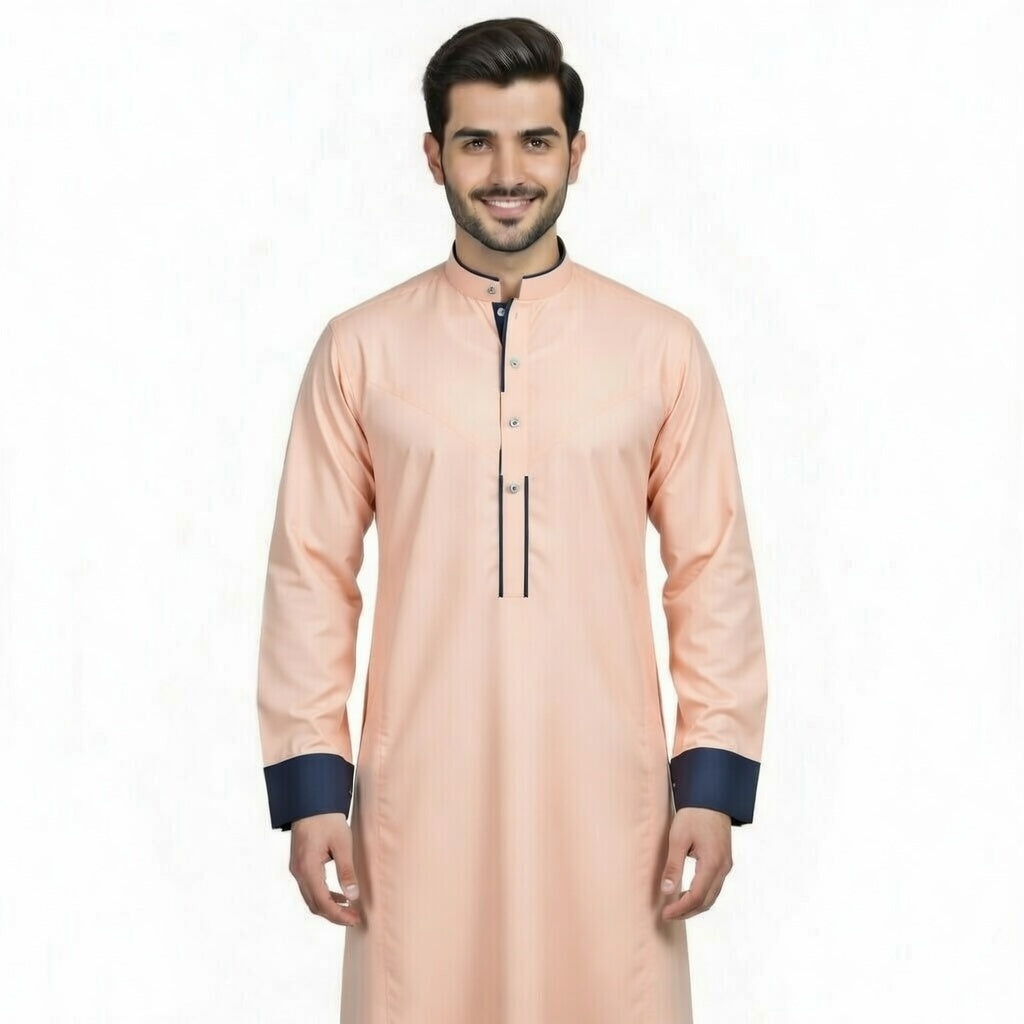 Man wearing a peach kurta with navy cuffs and trim on a white background