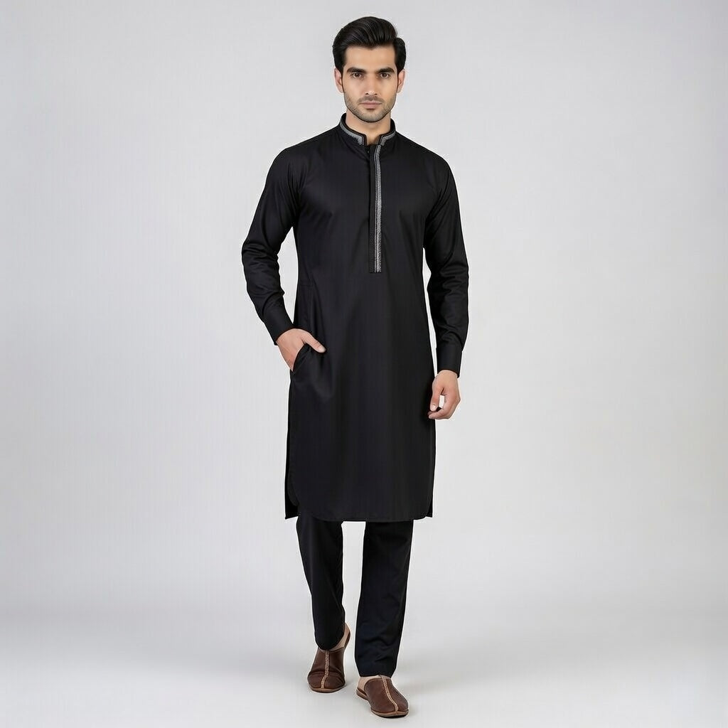 Man wearing a black kurta with a white background