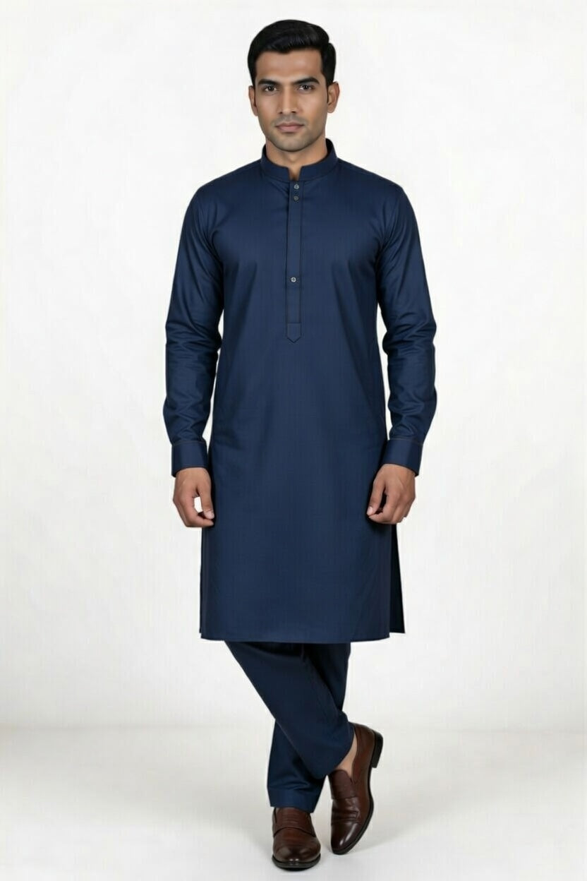 Man wearing a navy blue kurta with pants on a white background