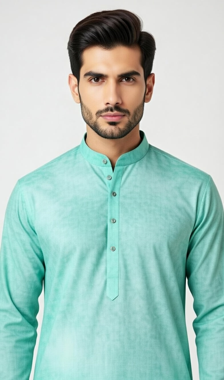 Man wearing a light green kurta against a plain background