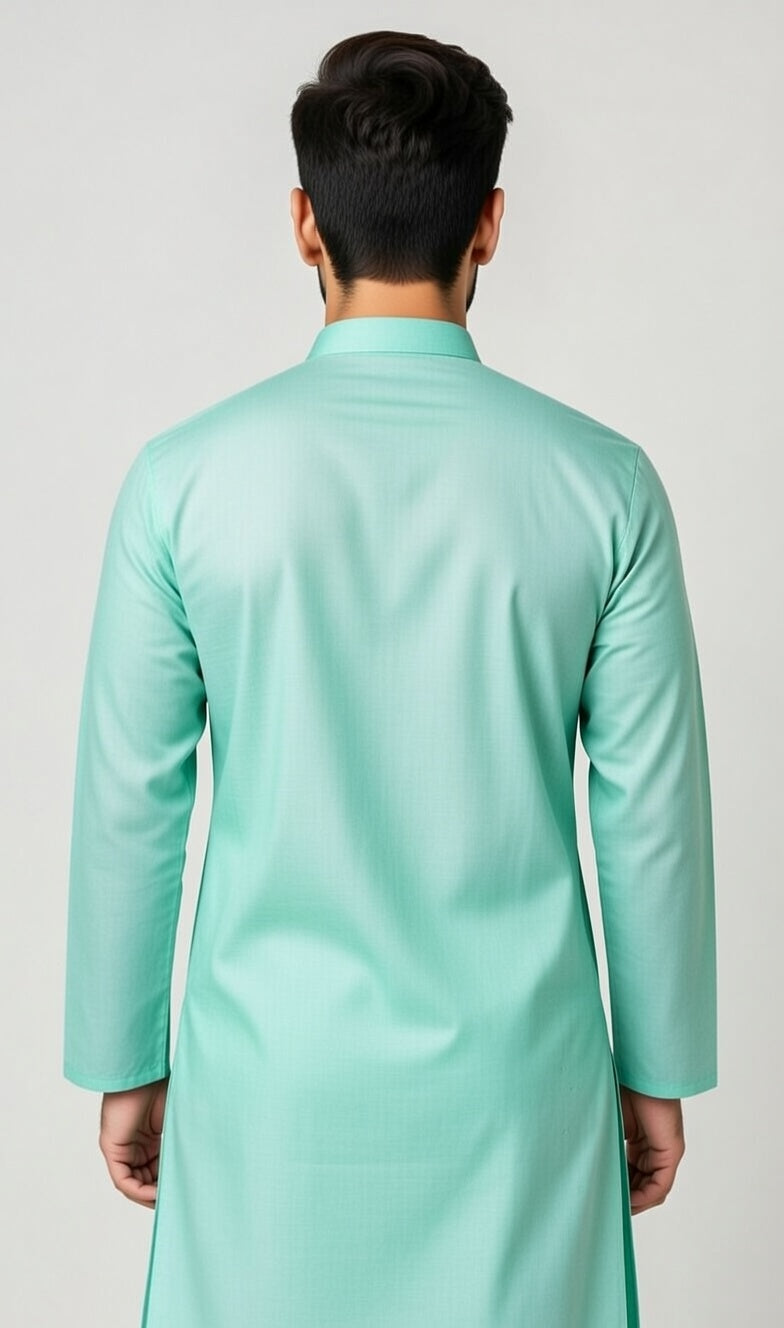 Man wearing a light green traditional outfit against a plain background