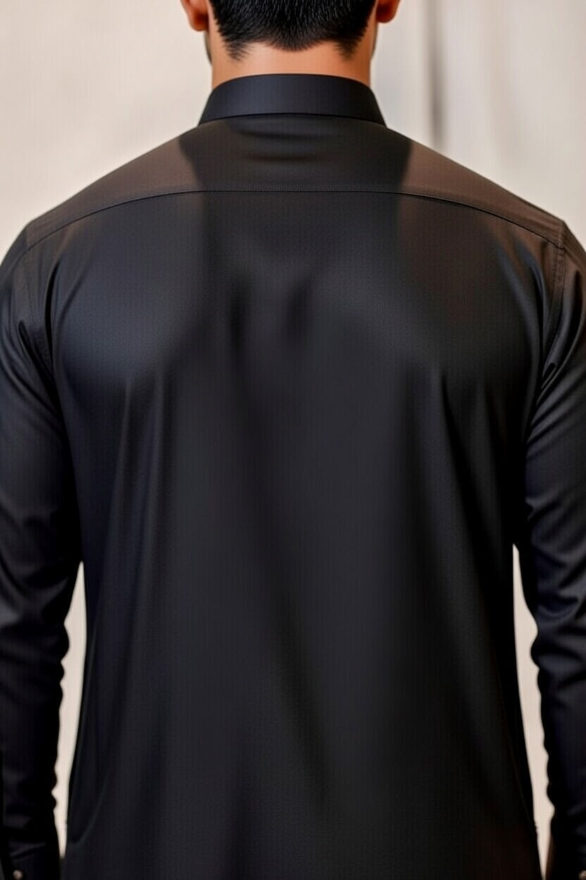 Black dress shirt worn by a person with a neutral background