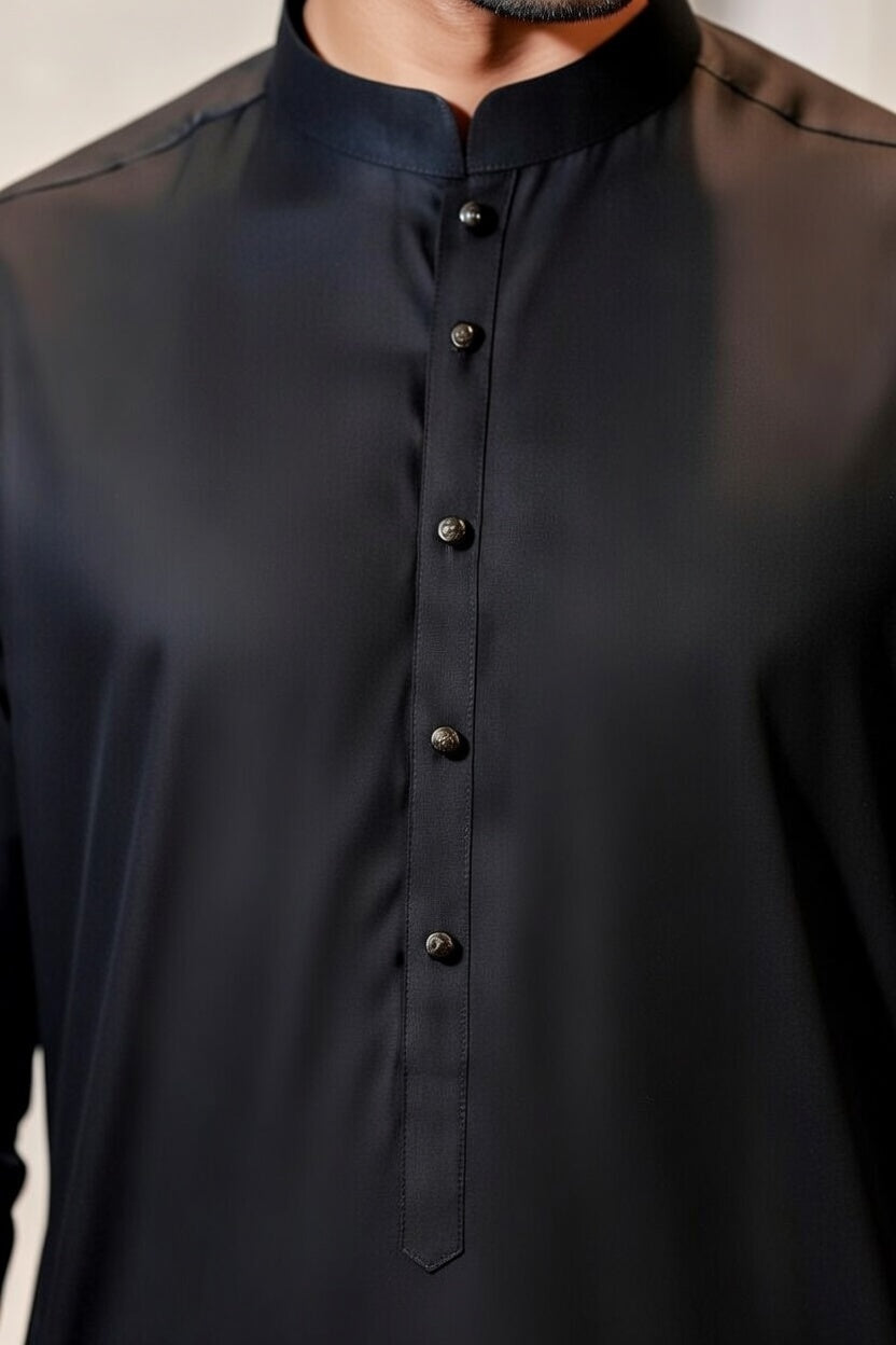 Black button-up shirt worn by a person, with a neutral background