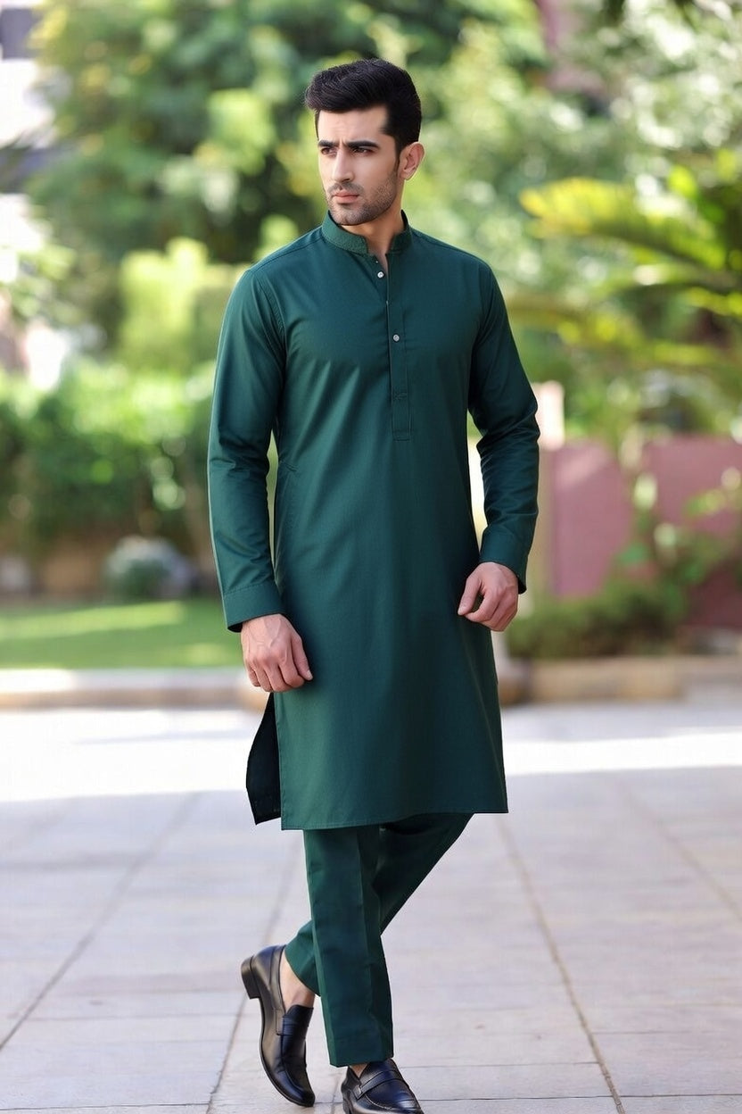 Man wearing a green kurta with pants outdoors on a sunny day.