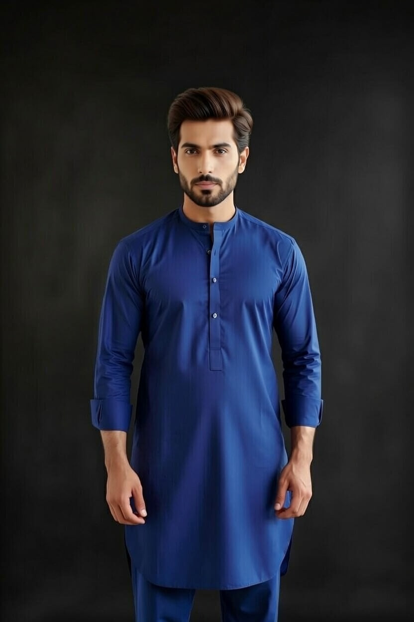 Man wearing a blue kurta against a black background