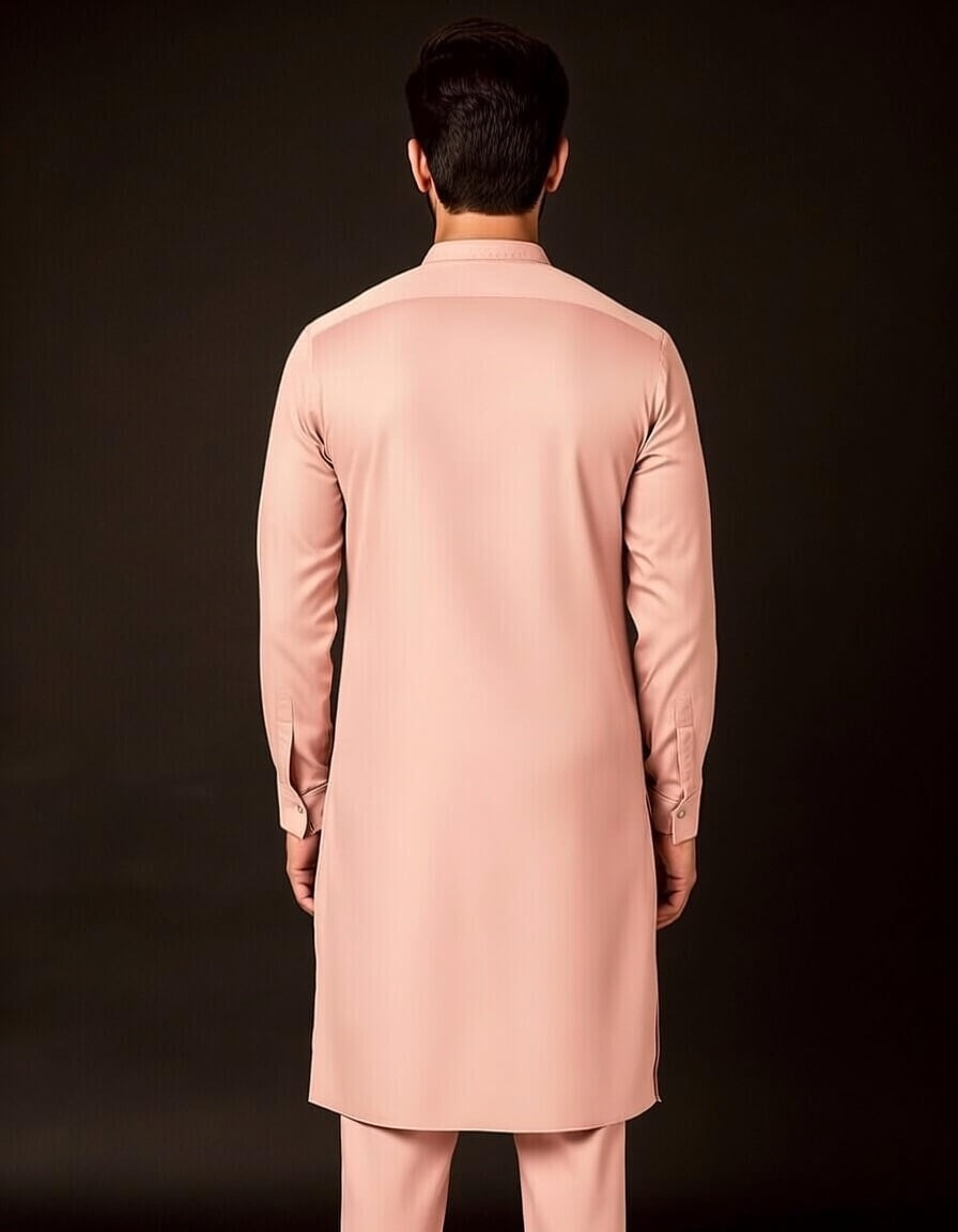 Person wearing a pink traditional outfit against a black background