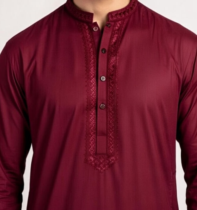 Maroon kurta with intricate embroidery on a plain background