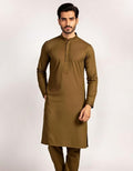 Man wearing a brown kurta with long sleeves on a white background