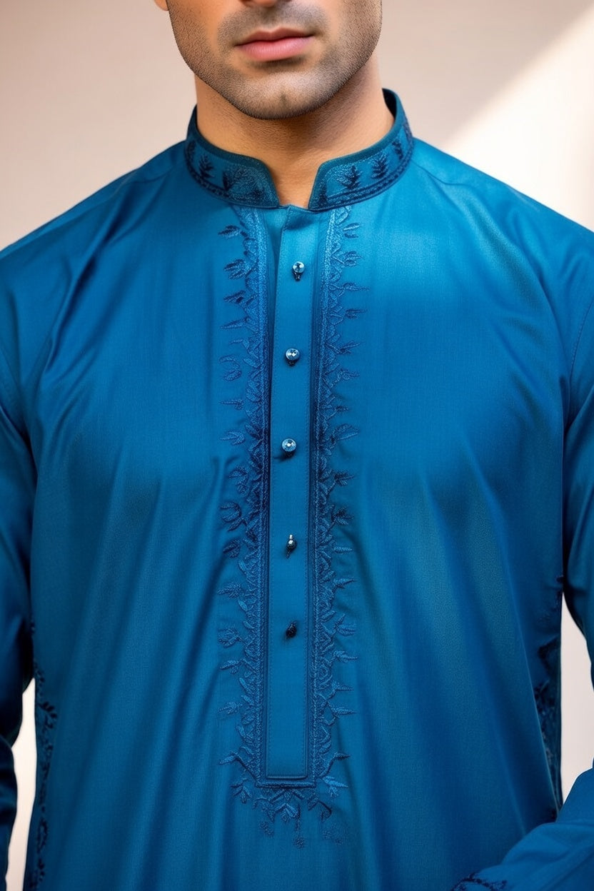Blue embroidered shirt worn by a person against a neutral background