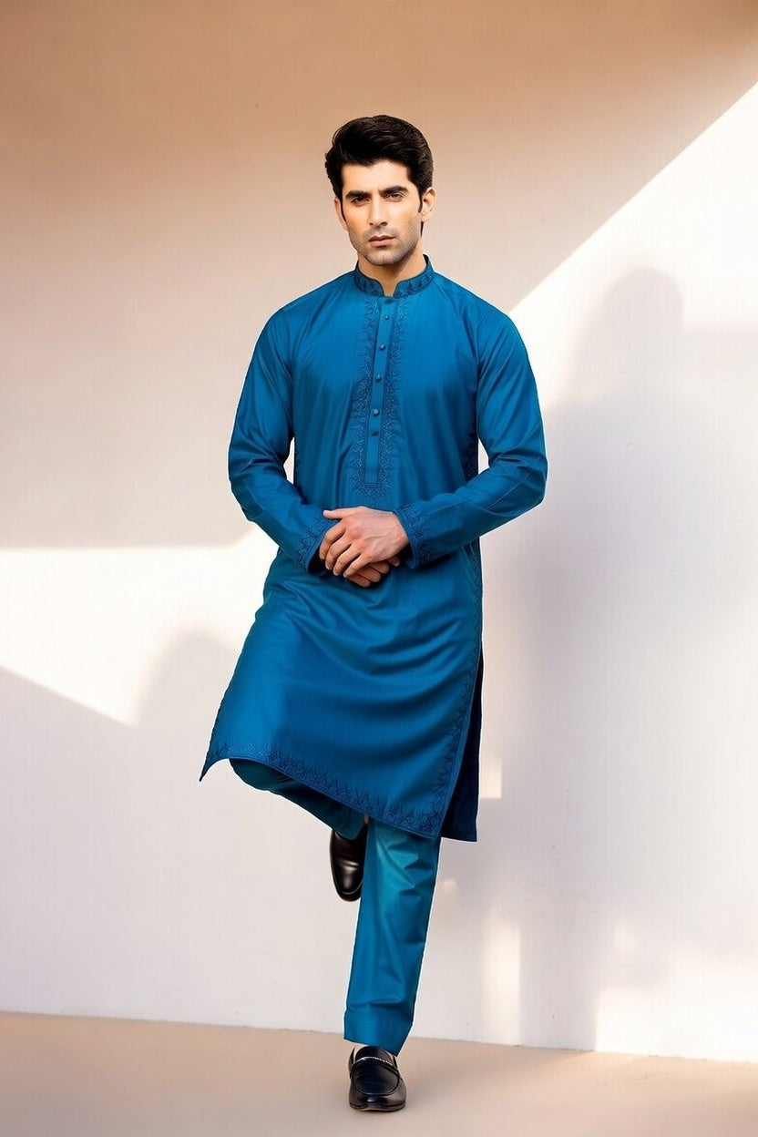 Man wearing a blue kurta with a plain background