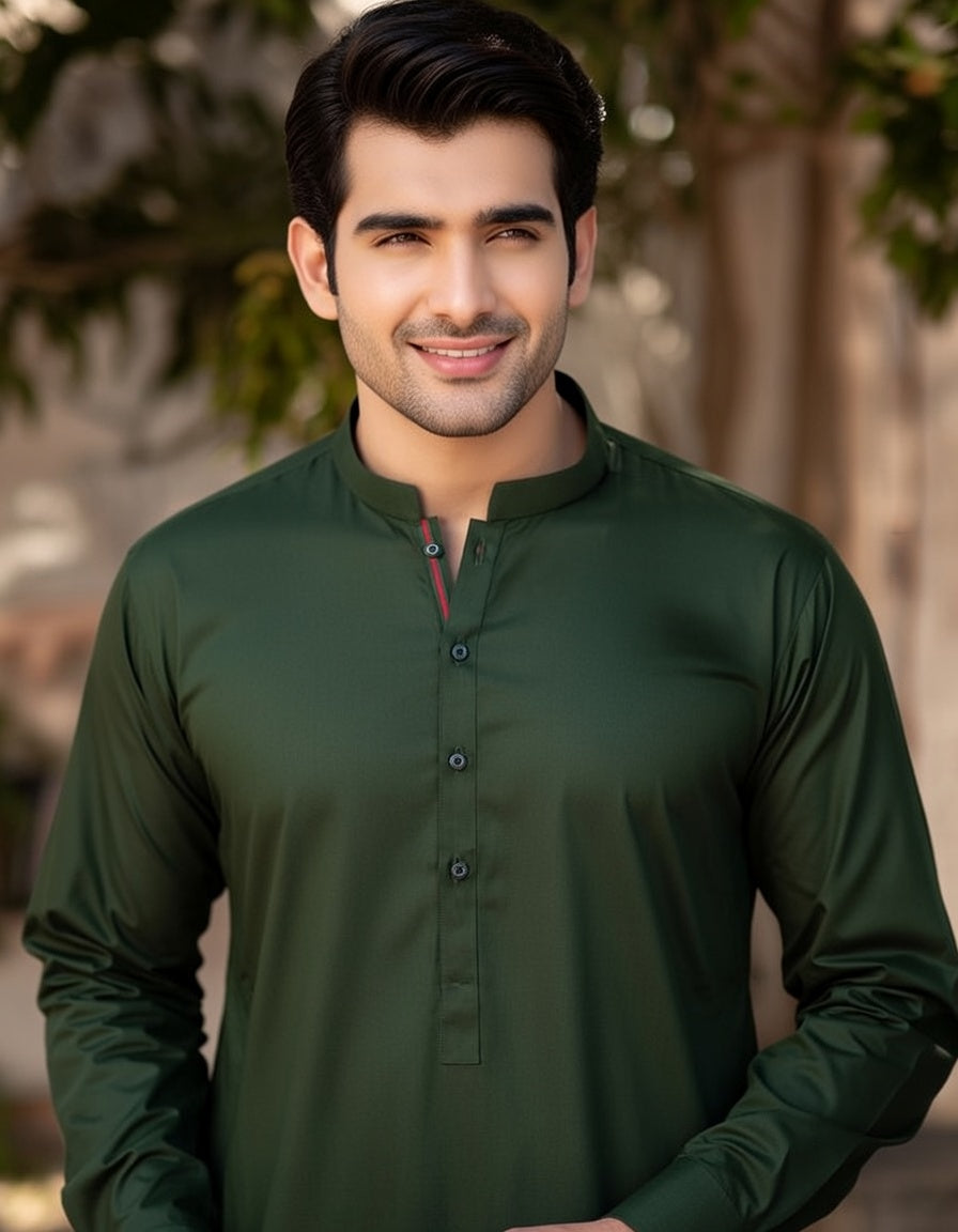 Man wearing a green shirt with a blurred natural background
