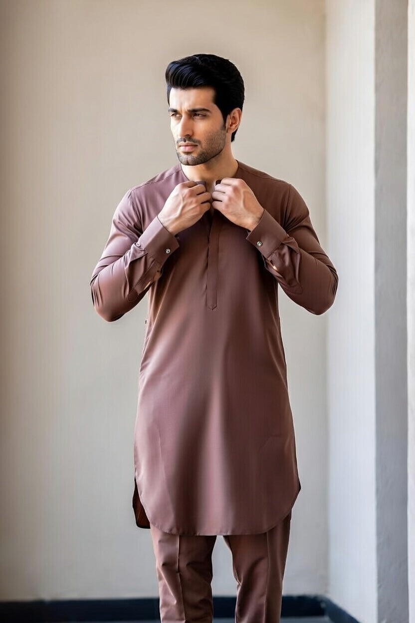 Man wearing a brown kurta with matching pants against a neutral background